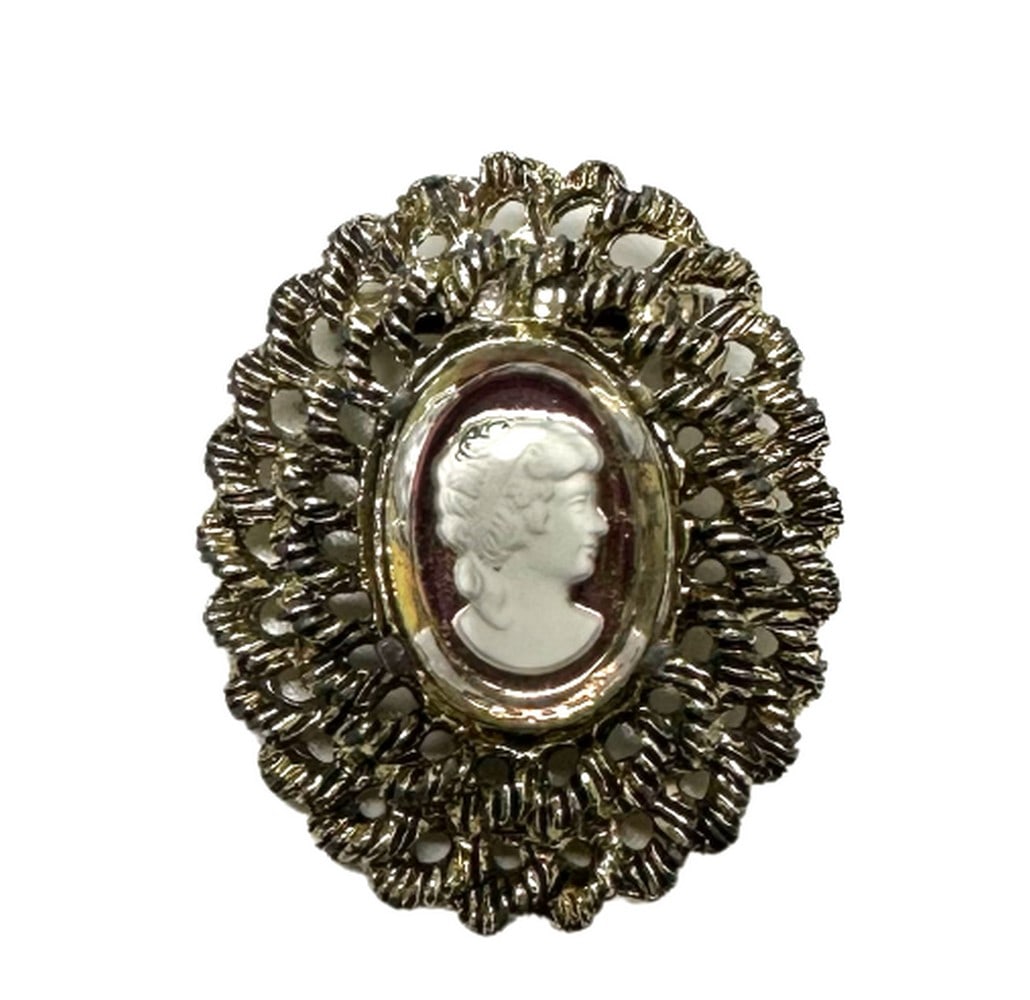 Vintage Bronze Toned Cameo Brooch Depicting A Silhouette Of A Victorian Beauty: Vintage Bronze Toned Cameo Brooch Depicting A Silhouette Of A Victorian Beauty The most popular cameos today are carved in sea shells, a tradition that began in the fifteenth or sixteenth century and