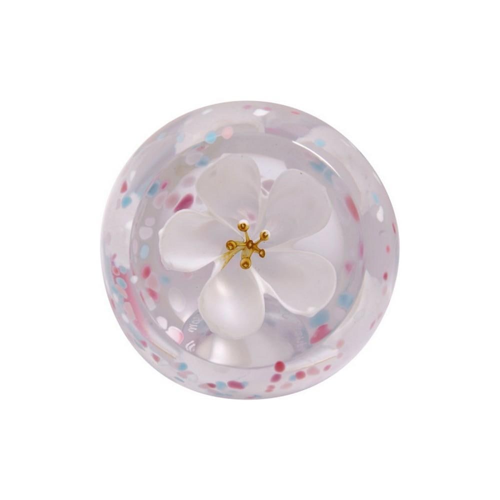 Ivory Petal Bloom Paperweight: Ivory Petal Bloom Paperweight A handcrafted glass paperweight featuring delicate blossoms suspended in translucent ivory glass, accented with soft dots of pastel pink and yellow. Each petal and hue