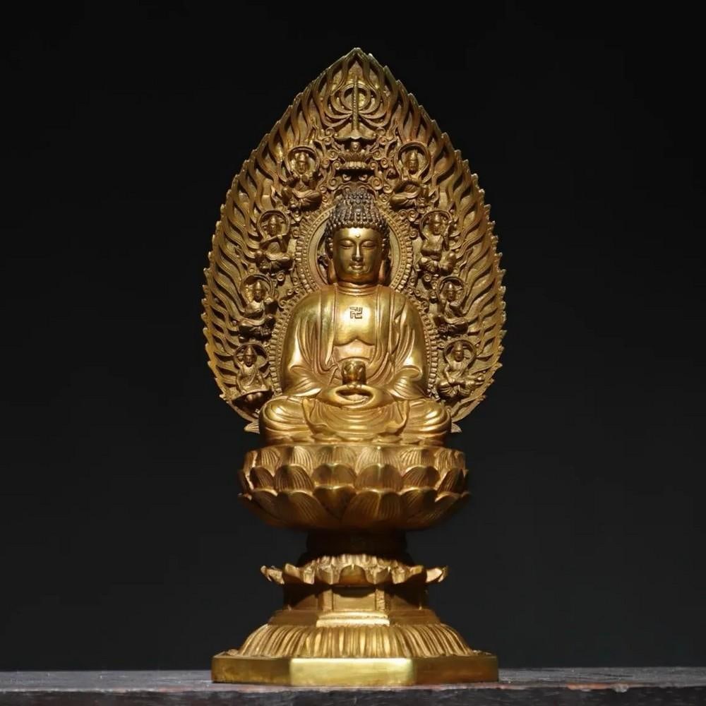 Pure Copper & Gilt Lamp Buddha Statue: Pure Copper & Gilt Lamp Buddha Statue This elegant Pure Copper & Gilt Lamp Buddha Statue showcases a Buddha seated gracefully with a lamp in hand, symbolizing the illumination of wisdom. Craft