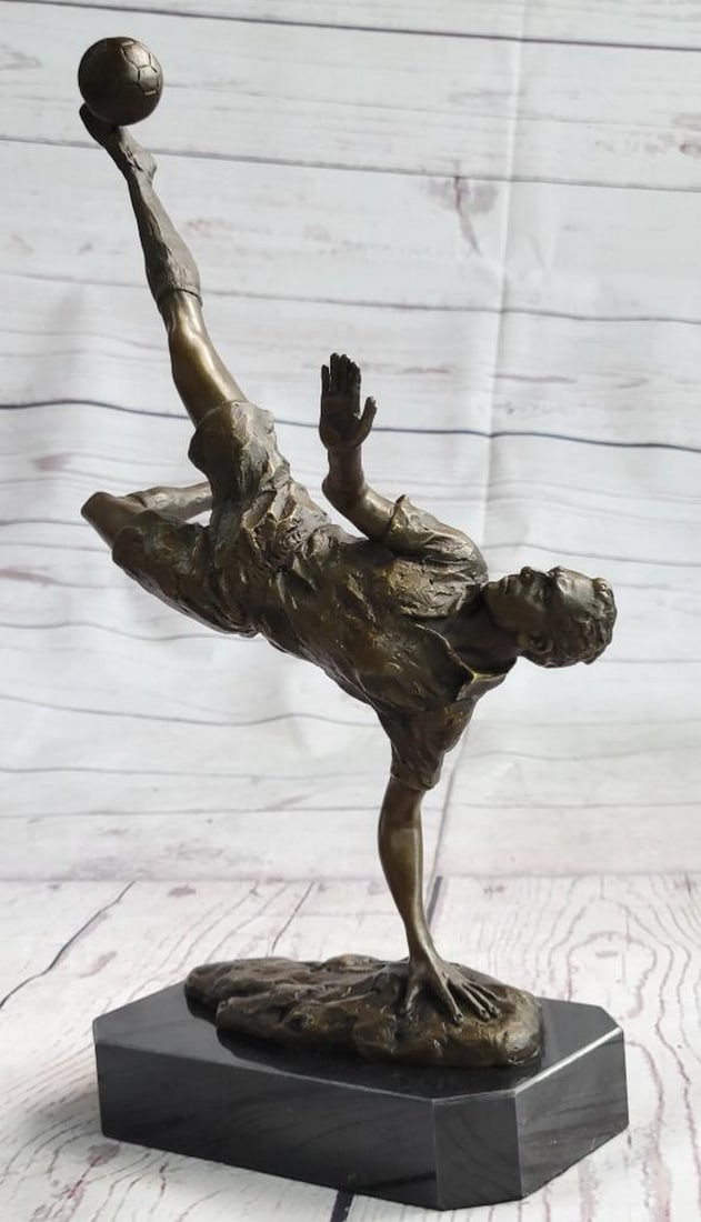 Signed Milo Original Soccer Trick Shot Bronze Sculpture - 14" x 10": Signed Milo Original Soccer Trick Shot Bronze Sculpture - 14" x 10" They are legend on the field. A soccer player tumbles down the grassy field, kicking, and dodging along the way. He is swift