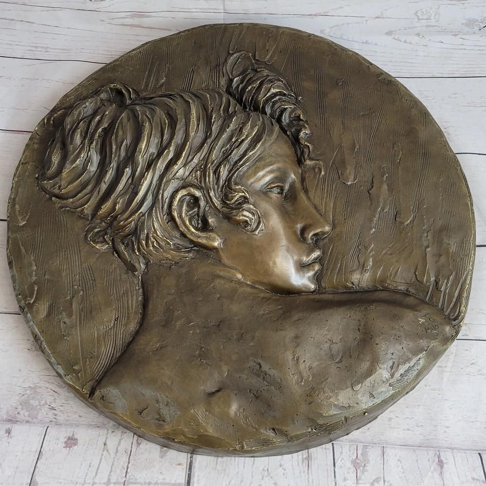 Art Nouveau Wall Hanging Bronze Plaque of a Woman's Profile - 17" x 17": Art Nouveau Wall Hanging Bronze Plaque of a Woman's Profile - 17" x 17" This beautiful wall piece depicts a the profile a young woman. Her expression is solemn. Freshly blossomed flowers s