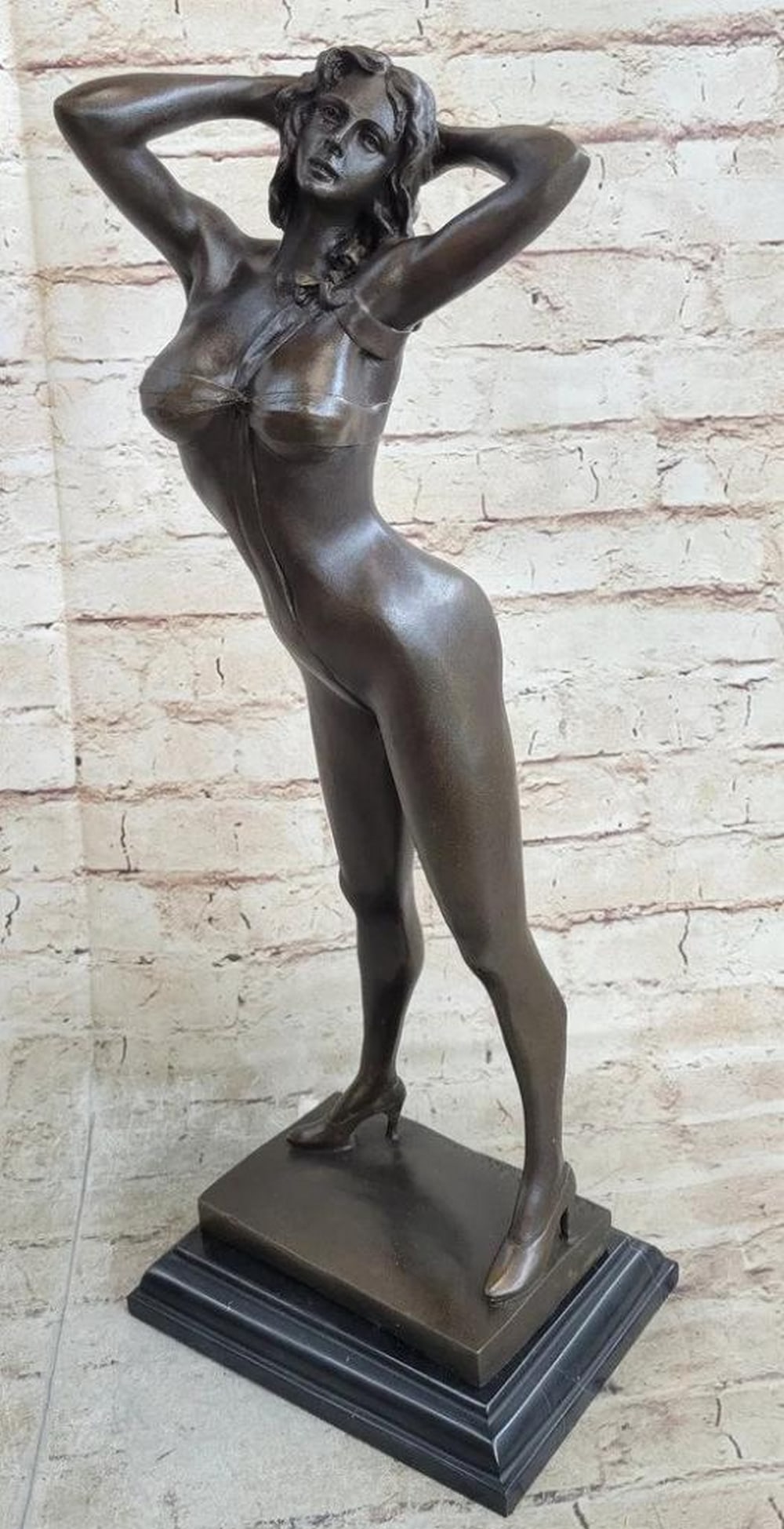 Sexy Girl Bronze Sculpture: Sexy Girl Bronze Sculpture This striking bronze sculpture captures the iconic allure of a Playboy Bunny centerfold in a dynamic and seductive pose. The female figure stands confidently with her back a