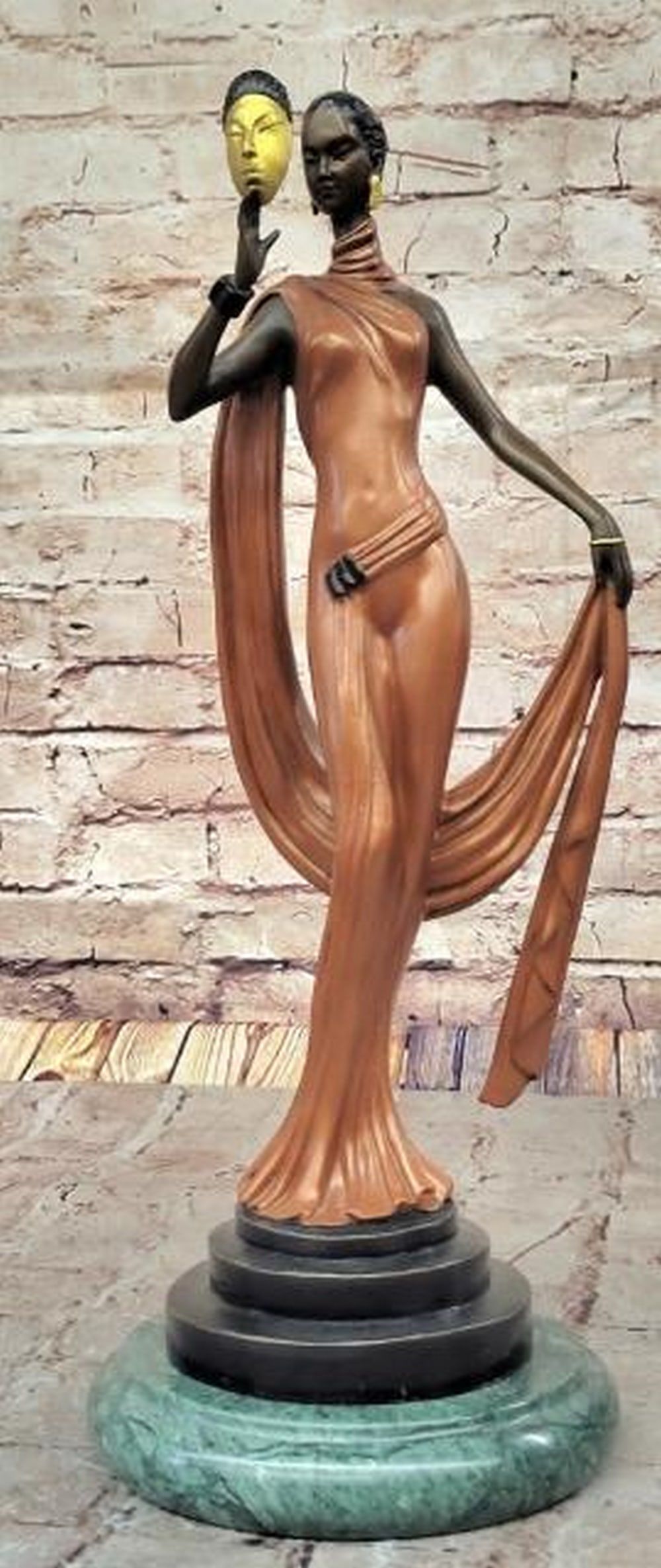 Golden Truth Bronze Sculpture -16.5" x 6": Golden Truth Bronze Sculpture -16.5" x 6". Inspired by and bearing the signature of artist Julius Erte, this striking bronze sculpture portrays a woman in a flowing pink dress, elegantly holdi
