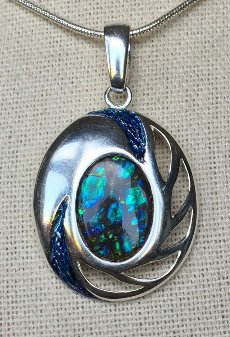 Solid Sterling Dragon Skin Ammolite Necklace Pendant: Solid Sterling Dragon Skin Ammolite Necklace Pendant This ammolite pendant is set in a substantial sterling silver setting, measuring 3.8cm x 2.3cm, with a 14mm x 10mm quartz-capped triplet gemstone