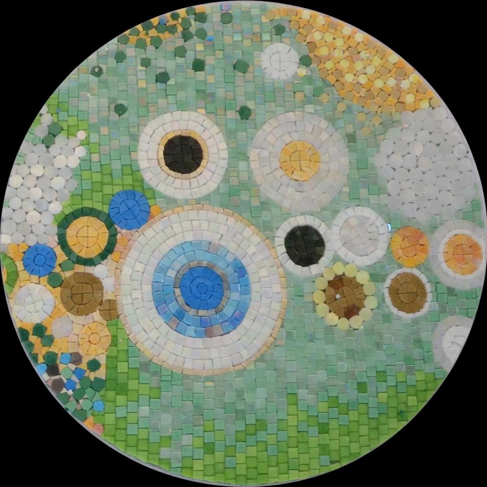 Geometric Rings Mosaic: Geometric Rings Mosaic A handcrafted mosaic made from glass stone. The piece features a circular pattern with multiple rings arranged in an abstract layout. Individually cut tiles are placed to