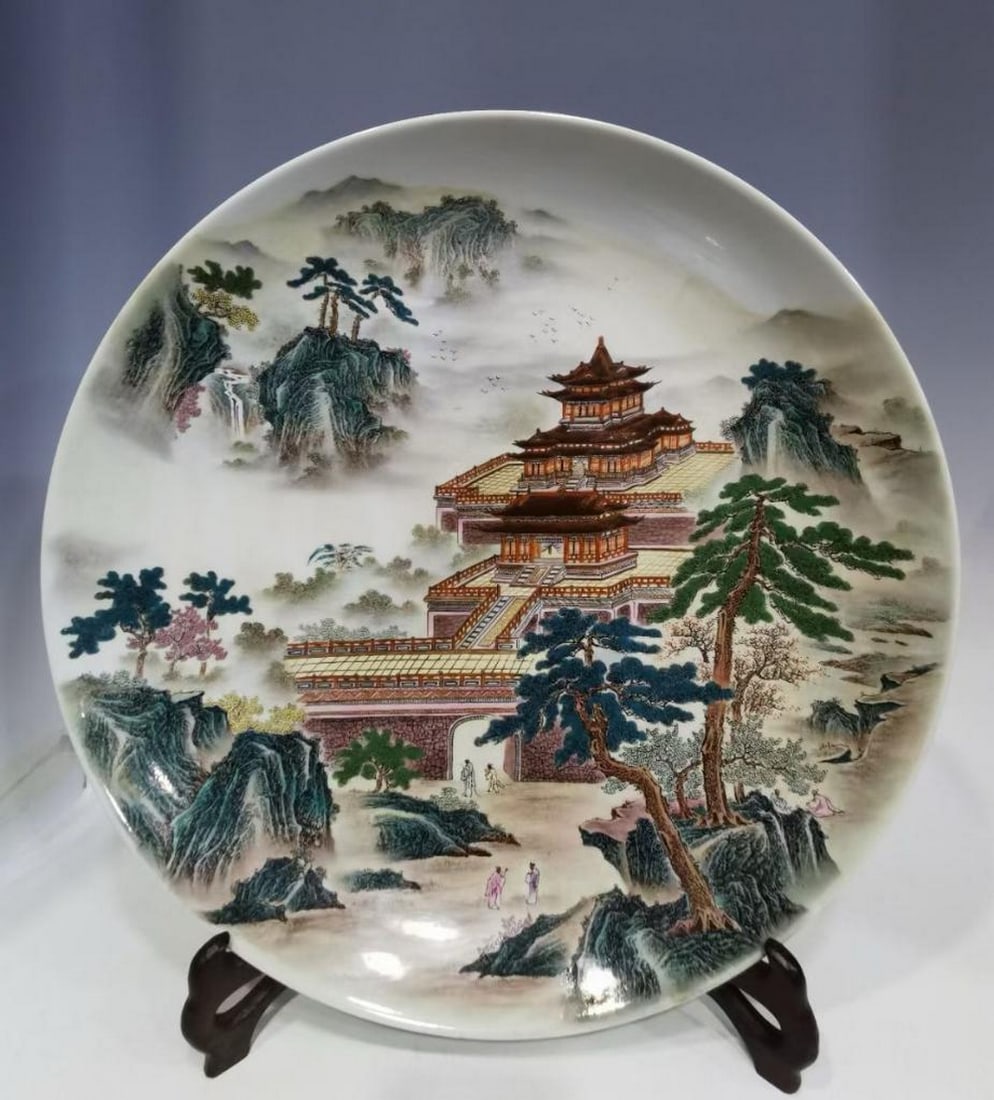 Yongzheng Era of the Qing Dynasty Famille Rose Landscape Plate: Yongzheng Era of the Qing Dynasty Famille Rose Landscape Plate A finely crafted porcelain plate from the Yongzheng period of the Qing Dynasty, decorated in vibrant famille rose enamels. The central sc