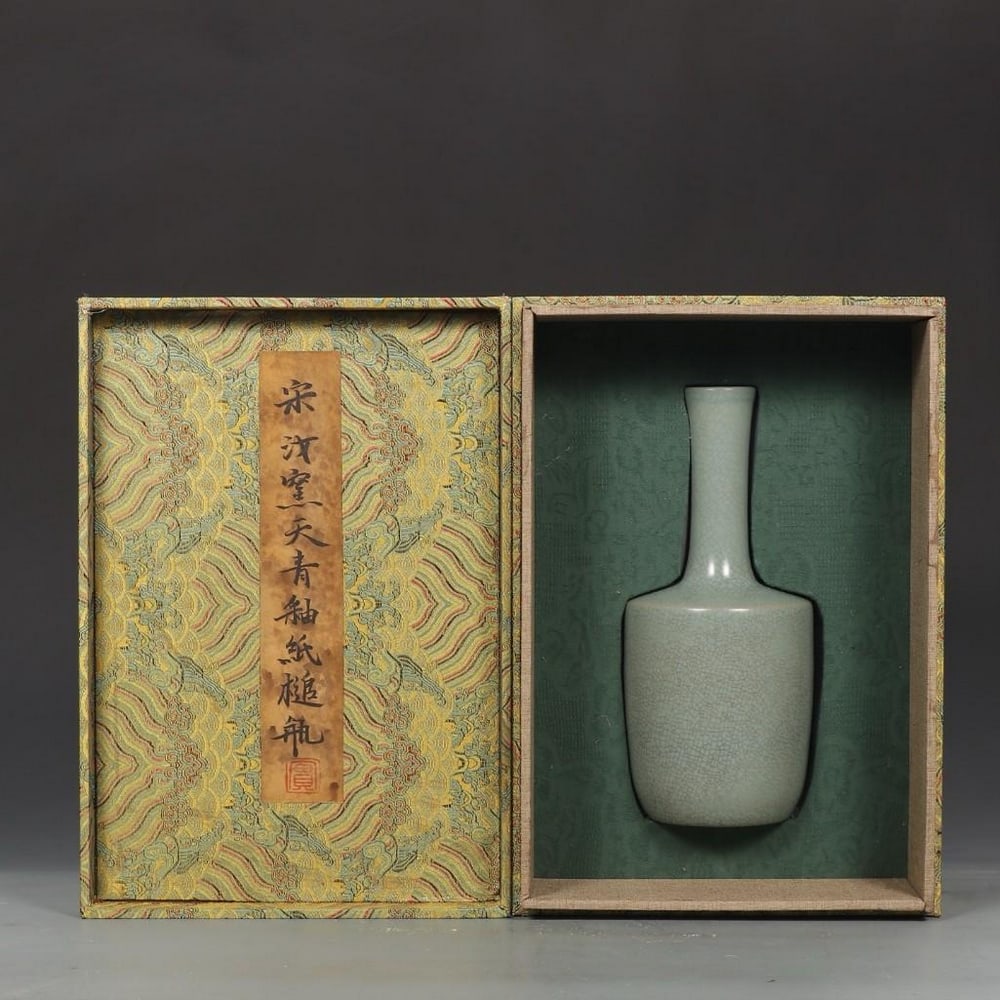 Old Collection Song Dynasty Ru Kiln Azure-Glazed Bottle: Old Collection Song Dynasty Ru Kiln Azure-Glazed Bottle A rare and elegant bottle from the Song Dynasty, crafted at the prestigious Ru kiln. The vessel is covered in a soft azure glaze with a fine, na