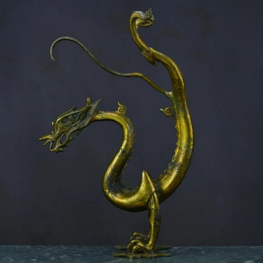 Antique Chinese Bronze Dragon Statue Ornament: Antique Chinese Bronze Dragon Statue Ornament This rare handcrafted bronze statue features a majestic dragon, symbolizing power, protection, and good fortune in Chinese culture. The intricate detailin