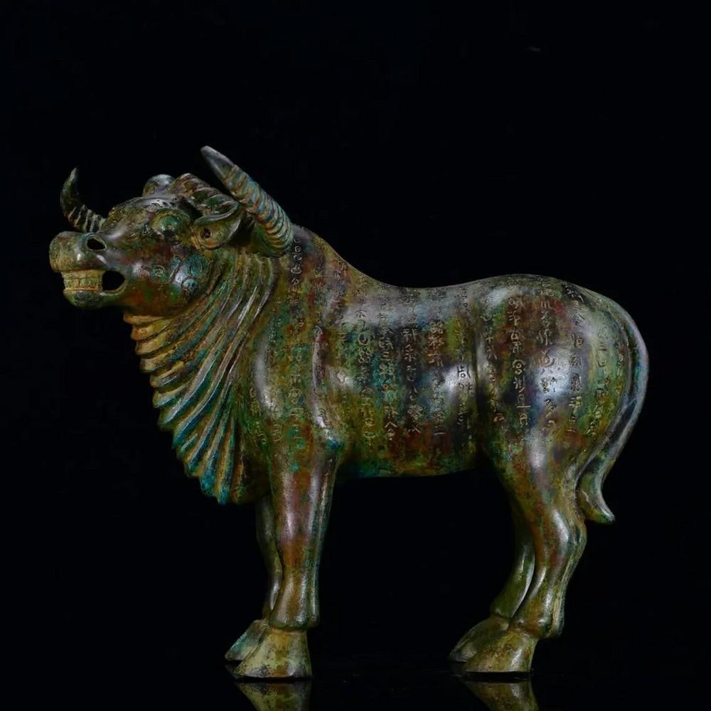 Antique Chinese Bronze Inscribed Cow Statue: Antique Chinese Bronze Inscribed Cow Statue This rare hand-crafted statue showcases traditional Chinese artistry, featuring a finely sculpted cow adorned with intricate bronze inscriptions. The detail
