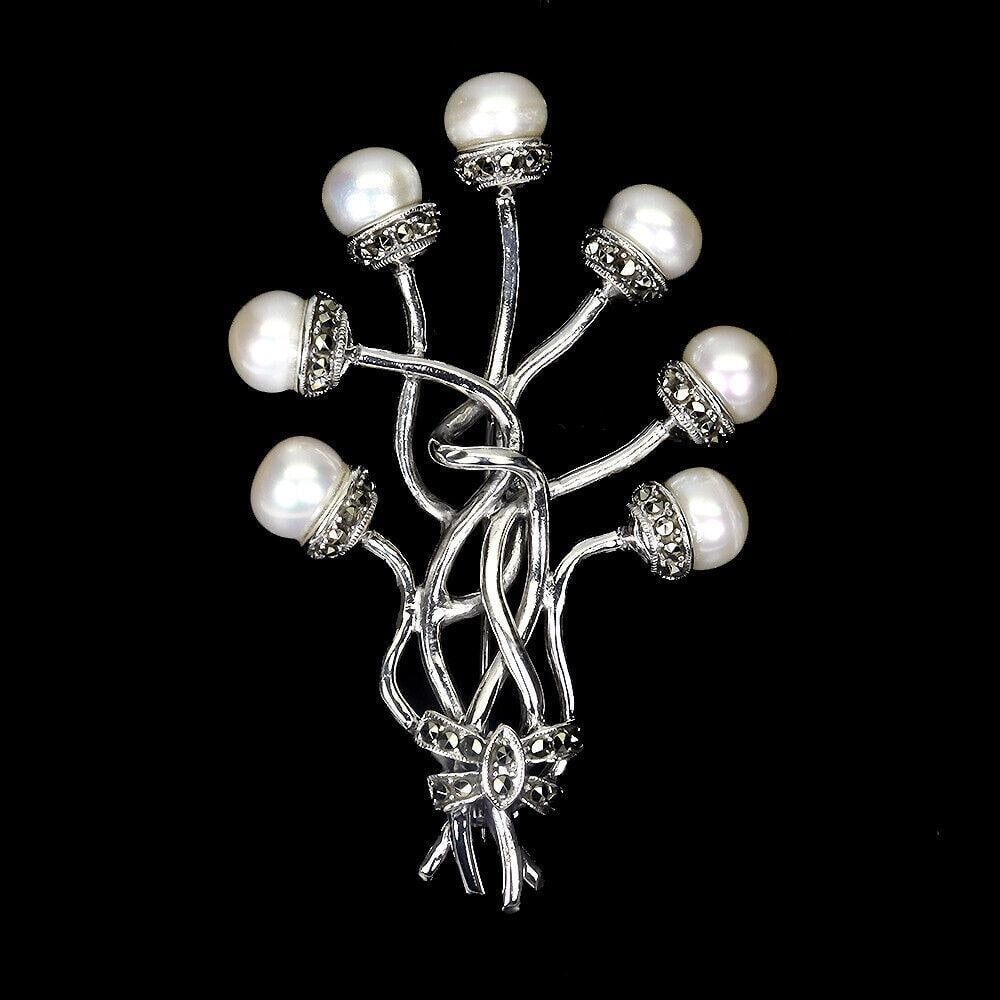 Natural Round Creamy White Pearl & Marcasite Sterling Silver Brooch: Natural Round Creamy White Pearl & Marcasite Sterling Silver Brooch Add a touch of classic elegance with the Natural Round Creamy White Pearl & Marcasite Sterling Silver Brooch. This exquisite