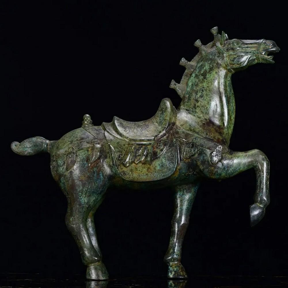 Antique Chinese War Horse Bronze Statue: Antique Chinese War Horse Bronze Statue This antique Chinese bronze statue depicts a powerful war horse, symbolizing strength, loyalty, and valor. The dynamic pose and finely detailed craftsmanship ca