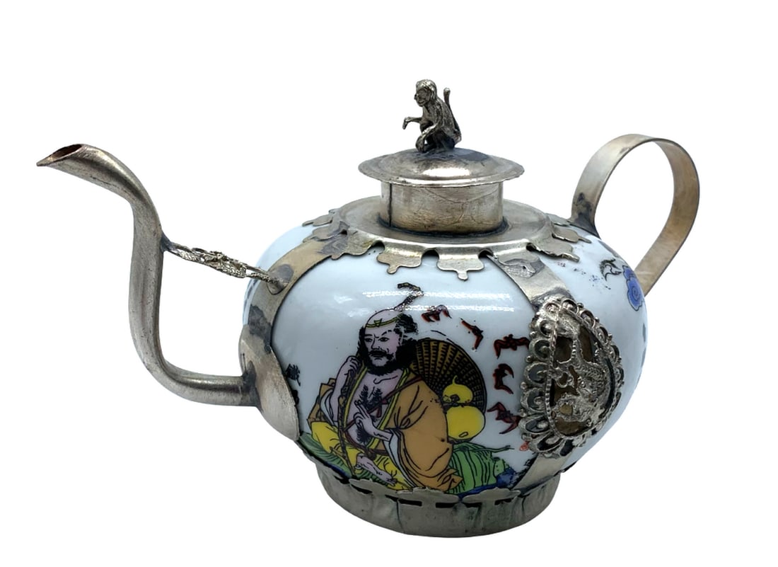Hand Painted Porcelain Teapot With Dragon Lion Monkey Armaments: Hand Painted Porcelain Teapot With Dragon Lion Monkey Armaments'. A Bulbous Centered & Balanced Hand-Painted Body, Finished In A Tibetan Silver Handle, Lid & Spout. Creatively Designed