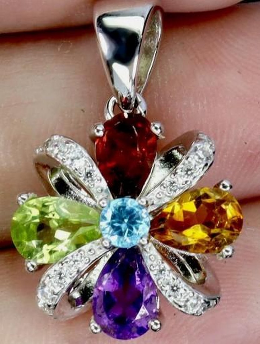 925 Sterling Silver Multi-Gemstone Pendant: 925 Sterling Silver Multi-Gemstone Pendant This elegant 925 sterling silver pendant features a beautifully arranged assortment of genuine gemstones. The polished sterling silver setting enhances the
