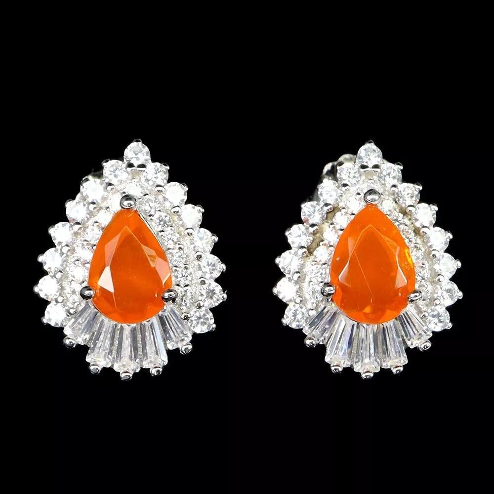 Heated Pear Orange Opal Earrings in 925 Sterling Silver: Heated Pear Orange Opal Earrings in 925 Sterling Silver These stunning earrings feature heated pear-shaped orange opal gemstones set in 925 sterling silver. The vibrant opals radiate a warm, fiery