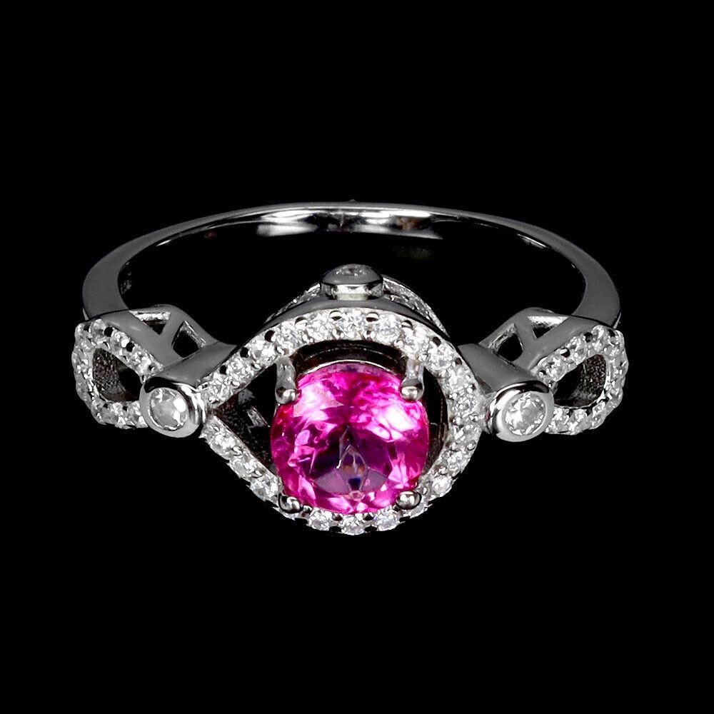 Pink Radiance Topaz 6mm Gemstone Ring: Pink Radiance Topaz 6mm Gemstone Ring Discover the enchanting allure of our exquisite pink topaz ring. The centerpiece of this stunning piece is a captivating pink topaz, expertly cut to showcase its 