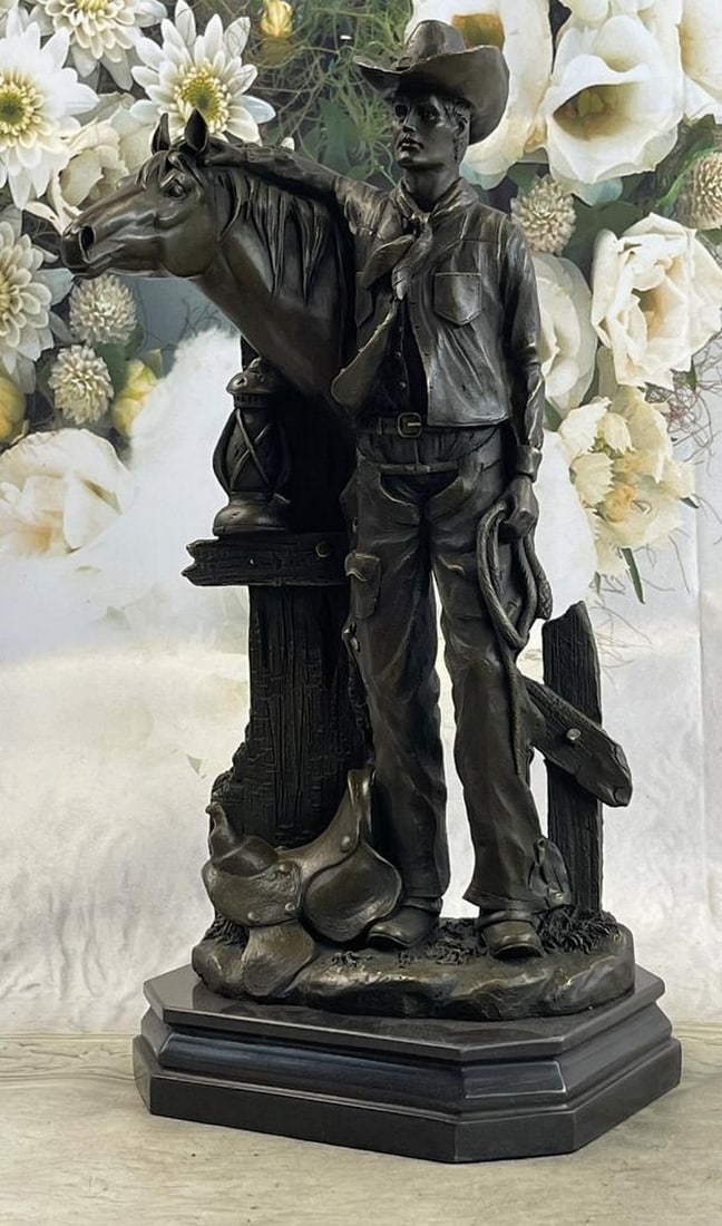 Cowboy Saddling Horse Bronze Statue by Kamiko - 16" x 8": Cowboy Saddling Horse Bronze Statue by Kamiko - 16" x 8" This captivating 16" x 8" bronze statue, Cowboy Saddling Horse, beautifully captures a moment of Western life. Featuring a cowb