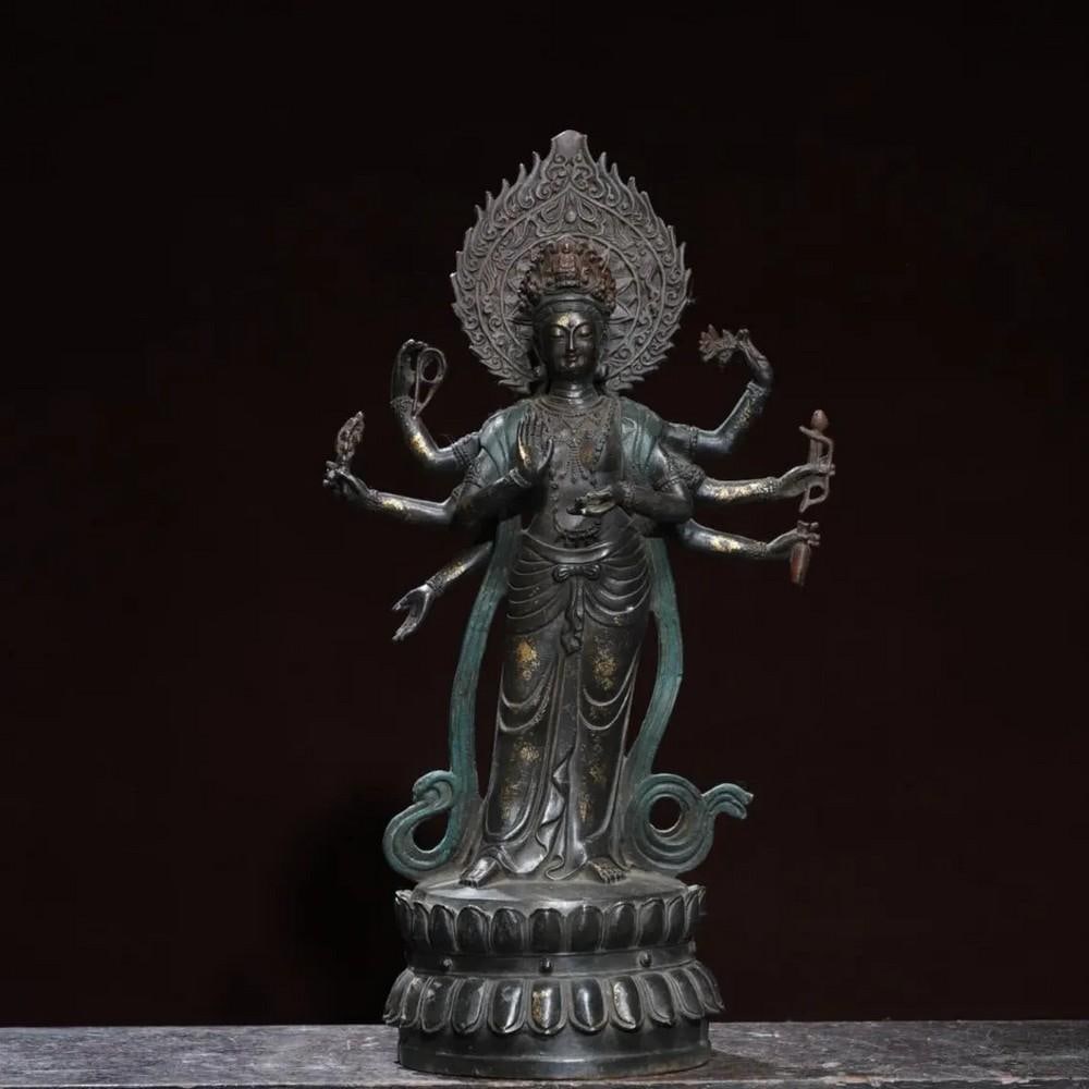 Eight-Armed Guanyin Buddha in Gilded Copper Chinese Statue: Eight-Armed Guanyin Buddha in Gilded Copper Chinese Statue This exquisite eight-armed Guanyin Buddha statue is a rare example of Chinese craftsmanship, hand-forged from pure copper and delicately gild