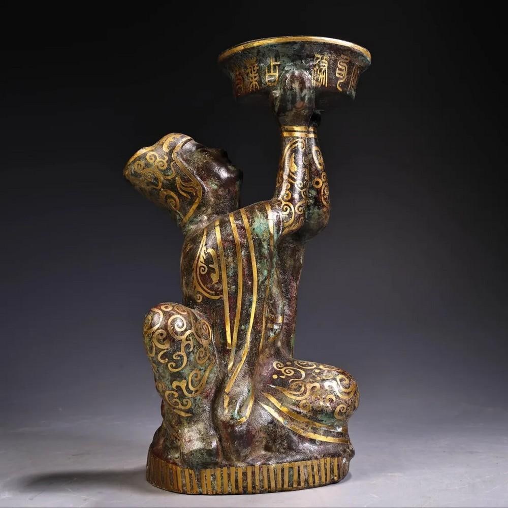 Antique Bronze Inlaid Gold Kneeling Oil Lamp Statue: Antique Bronze Inlaid Gold Kneeling Oil Lamp Statue This rare and masterfully handcrafted Chinese antique kneeling oil lamp statue embodies centuries of artistry and tradition. Made from pure bronze a