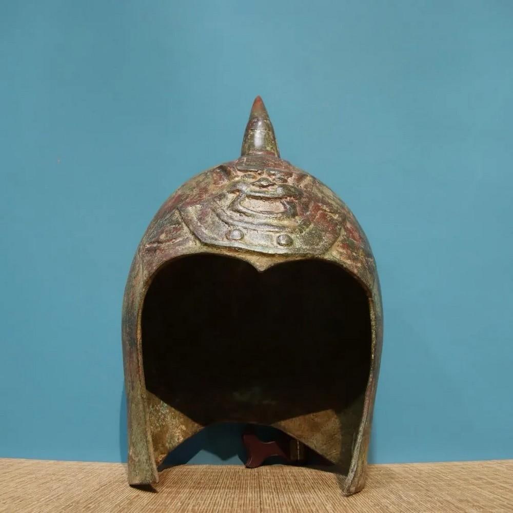 Antique Chinese Bronze General Helmet Ornament: Antique Chinese Bronze General Helmet Ornament This antique Chinese bronze general helmet ornament represents the strength and leadership of ancient warriors. Crafted with detailed engravings and a bo