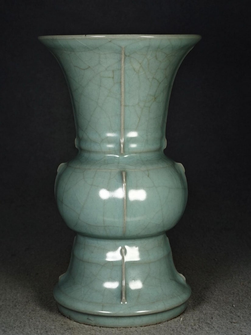 Chinese Style Longquan Porcelain Cut-Out Flower Vase: Chinese Style Longquan Porcelain Cut-Out Flower Vase This vase features a Longquan-style porcelain body with a cut-out flower design in a Chinese-inspired form. The surface displays openwork detailing