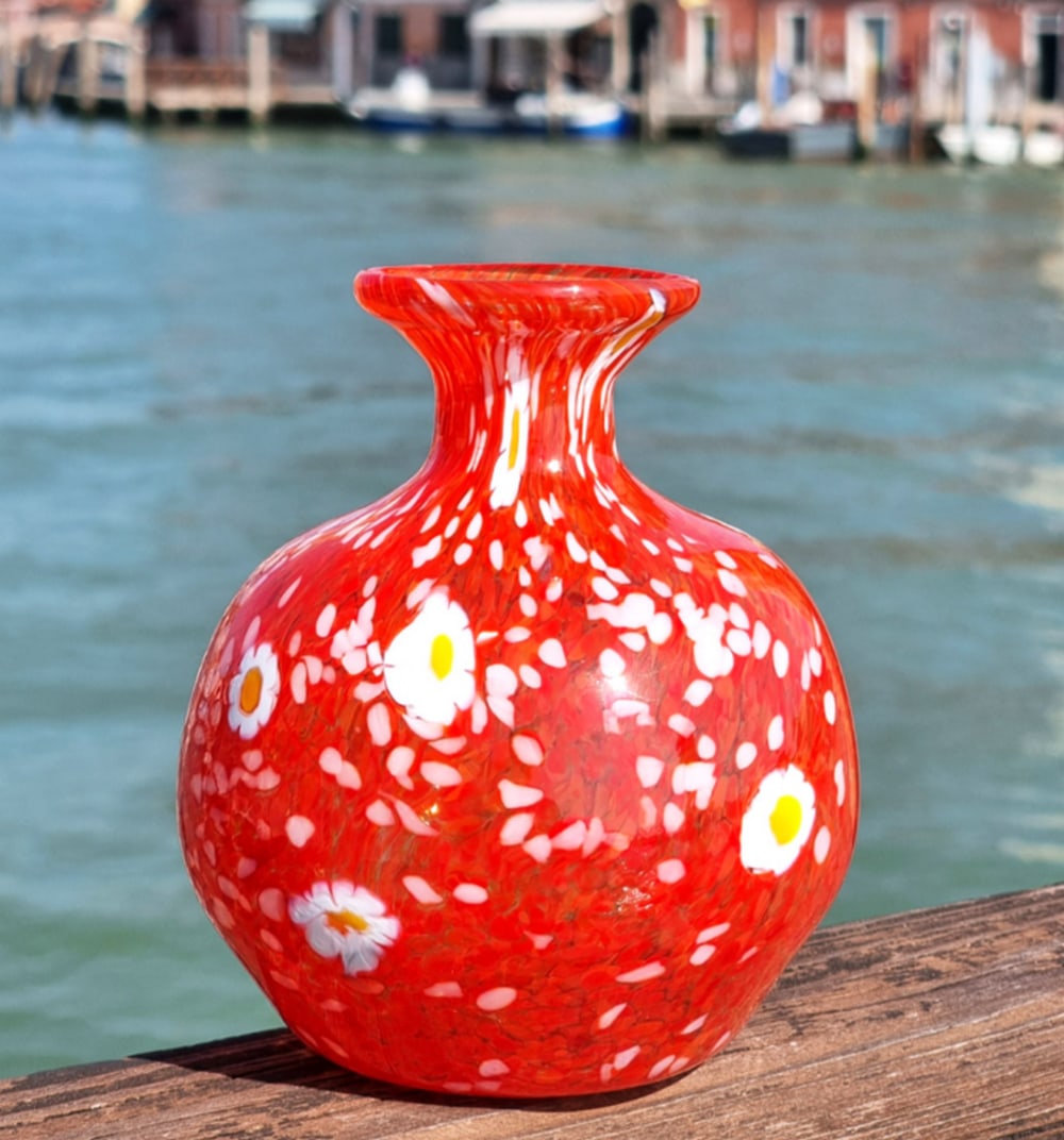 Murano Glass Red Murrine Vase: Murano Glass Red Murrine Vase This Murano glass vase is made using the blown glass technique and decorated with murrina (millefiori) canes embedded within the glass. The vase is hand blown and shaped,