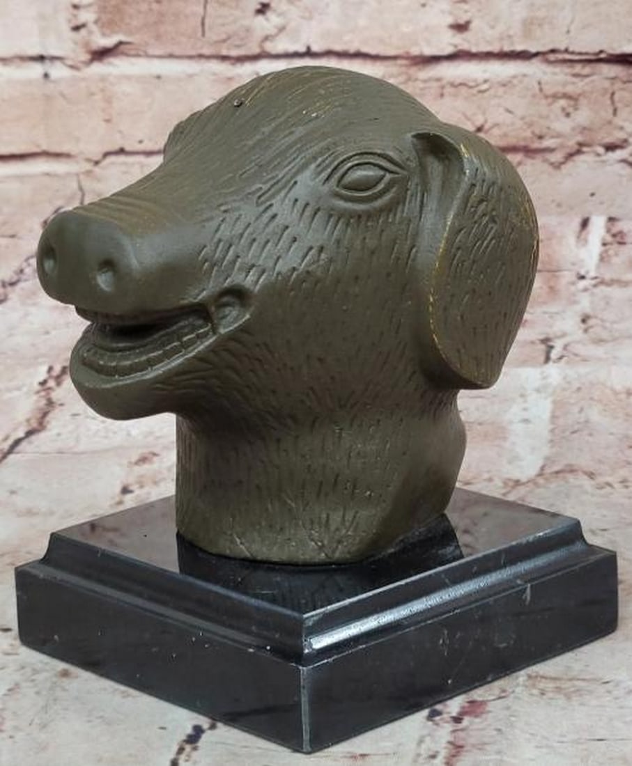 Joyful Fortune: Smiling Bronze Pig Head Sculpture: Joyful Fortune: Smiling Bronze Pig Head Sculpture Radiating warmth and good cheer, this bronze sculpture bearing the signature of artist Yanez, is of a smiling pig head and is a delightful symbol of a