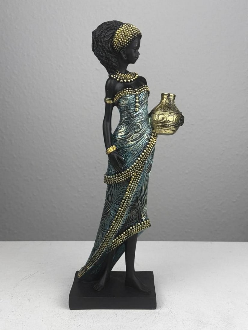 The Water Bearer – African Woman Resin Statue: The Water Bearer – African Woman Resin Statue This graceful figure carries a vessel in a traditional pose, celebrating strength and heritage. A meaningful sculpture that adds cultural depth and eleg