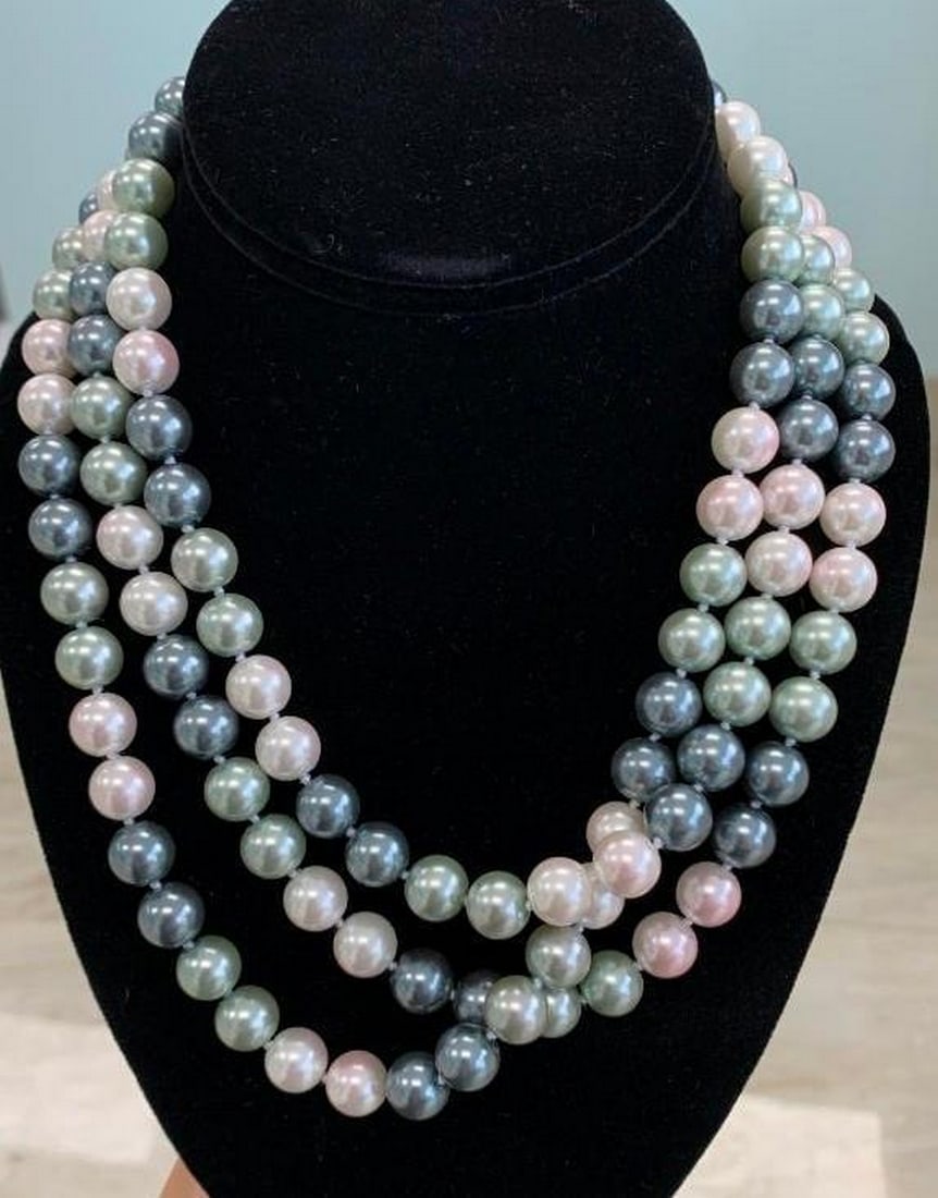Pastel Symphony: Cascading Beads of Elegance: Pastel Symphony: Cascading Beads of Elegance This multi-strand necklace dances with polished beads in soft hues of pink, green, blue, and gray. Layered gracefully, each strand adds depth and charm, wh