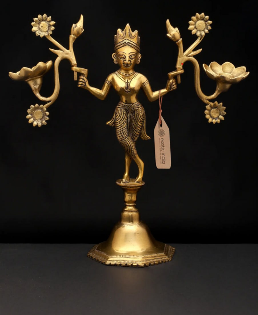 12" Mythical Grace with Radiant Bloom Candle Holder: 12" Mythical Grace with Radiant Bloom Candle Holder Brass candle holder depicting a graceful mythical figure adorned with floral motifs. The design merges artistic sculpture with functional purpos