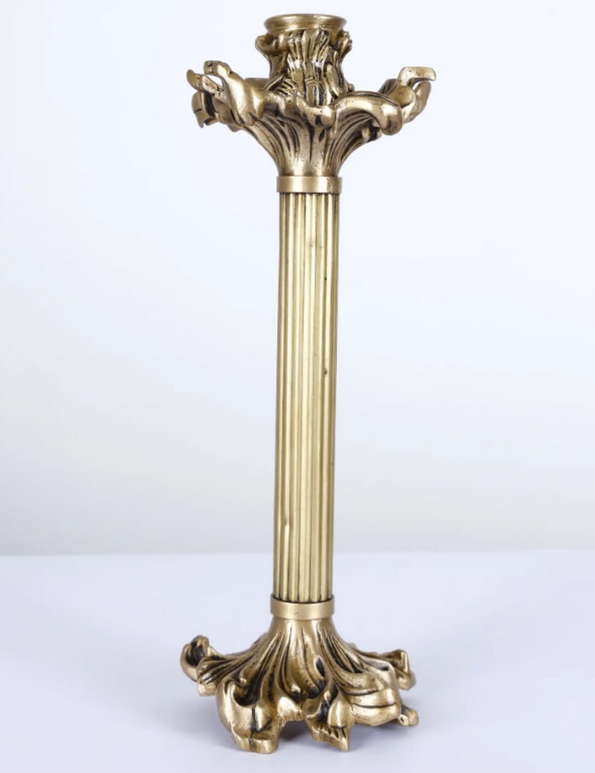 Brass Corinthian Column Candle Holder – 11": Brass Corinthian Column Candle Holder – 11" An 11.5-inch brass candle holder designed in the form of a Corinthian column. The piece features fluted detailing on the shaft and a capital decorated