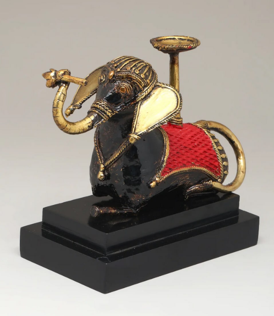 Brass Elephant with Candle Stand on Wooden Base – Dhokra Art: Brass Elephant with Candle Stand on Wooden Base – Dhokra Art An 8-inch brass elephant sculpture featuring an integrated candle stand, mounted on a solid wooden base. Crafted in the Dhokra tradition 