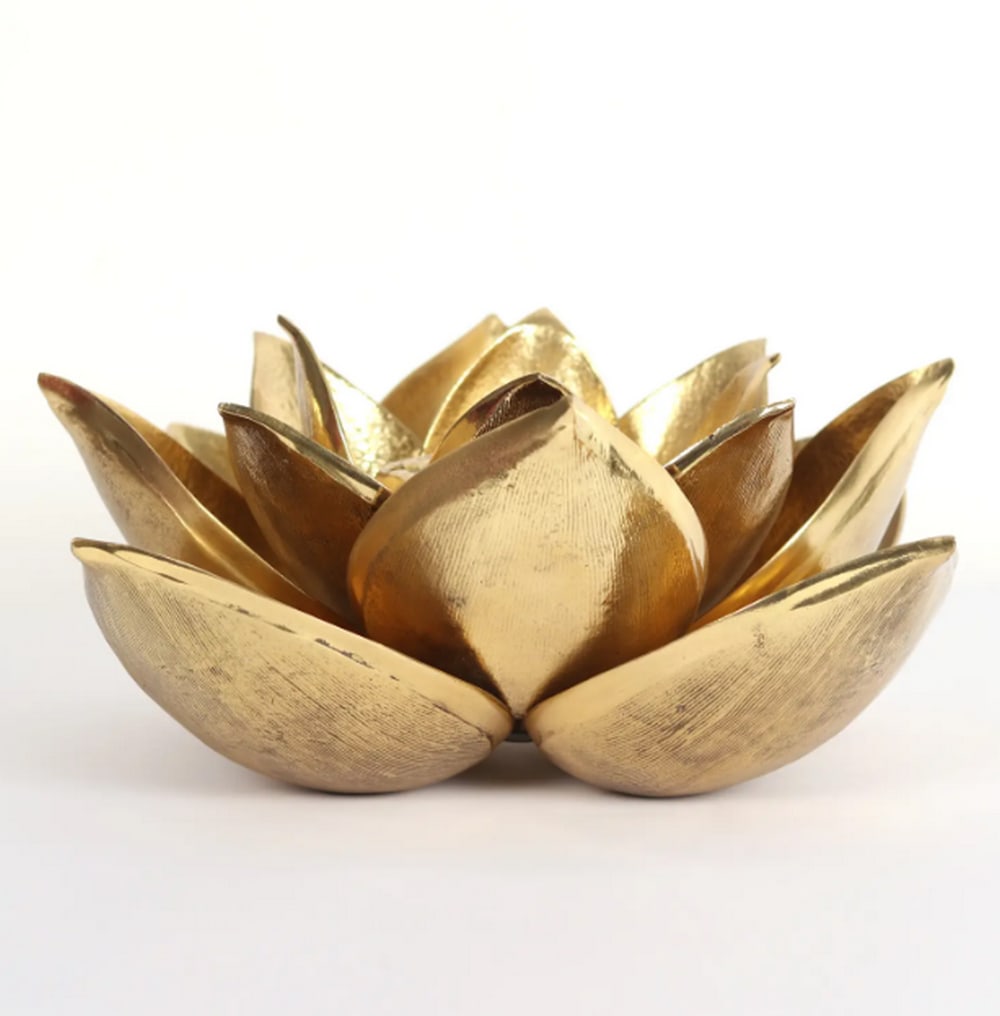 Brass Lotus Candle Holder – 6": Brass Lotus Candle Holder – 6" A 6.2-inch brass candle holder shaped like a blooming lotus flower. The piece features individually sculpted petals with a subtly textured finish, capturing the de