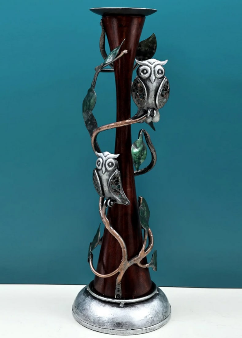 19" Decorative Owl Candle Holder: 19" Decorative Owl Candle Holder Candle holder crafted from iron, featuring multiple owl figures perched on stylized branches that surround the central candle space. The design incorporates both d