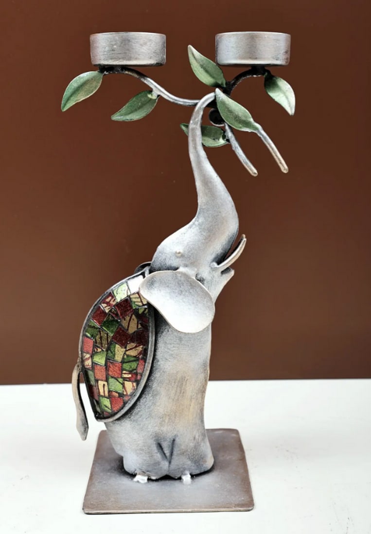 11" Handmade Candle Holder on Elephant Trunk: 11" Handmade Candle Holder on Elephant Trunk Candle holder made from iron, featuring an elephant trunk design that holds a single candle. Handmade with attention to detail, this piece combines fun