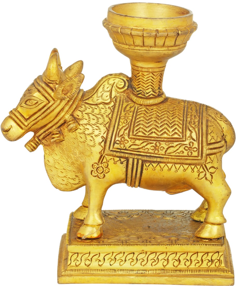 5.7" Nandi Candlestand: 5.7" Nandi Candlestand Crafted from brass, this candlestand features the figure of Nandi, the sacred bull and mount of Lord Shiva. The design includes a compartment for holding a candle above the 