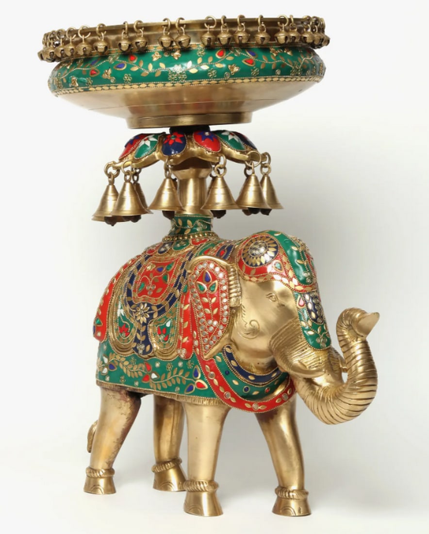20" Inlay Urli with Bells on Royal Elephant: 20" Inlay Urli with Bells on Royal Elephant Brass urli featuring a detailed royal elephant figure adorned with inlay work on its blanket and nettipattam. Embellished with bells and engraved floral