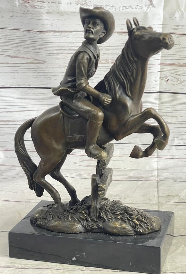 Cowboy Jumping Fence on the Plains Inspired Bronze Statue - 11" x 10": Cowboy Jumping Fence on the Plains Inspired Bronze Statue - 11" x 10" The piece depicts a cowboy in full gallop, expertly guiding his horse over a fence on the open plains. The fine details of