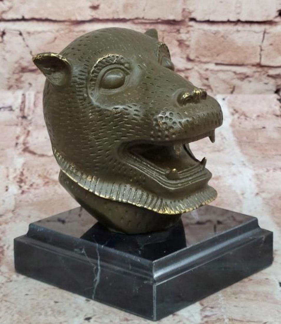 Fierce Majesty: Bronze Tiger Head Bust: Fierce Majesty: Bronze Tiger Head Bust Commanding and intense, this bronze bust sculpture captures the raw power and regal presence of the tiger. The finely sculpted head features piercing eyes, a pow