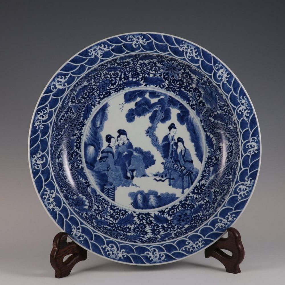 Qing Dynasty Kangxi-Inspired Blue and White Plate Featuring a Dragon, Entwined Lotus, & Lady Design: Qing Dynasty Kangxi-Inspired Blue and White Plate Featuring a Dragon, Entwined Lotus, & Lady Design An inspired grand blue and white porcelain plate in the style of the Kangxi period (1662–1722)
