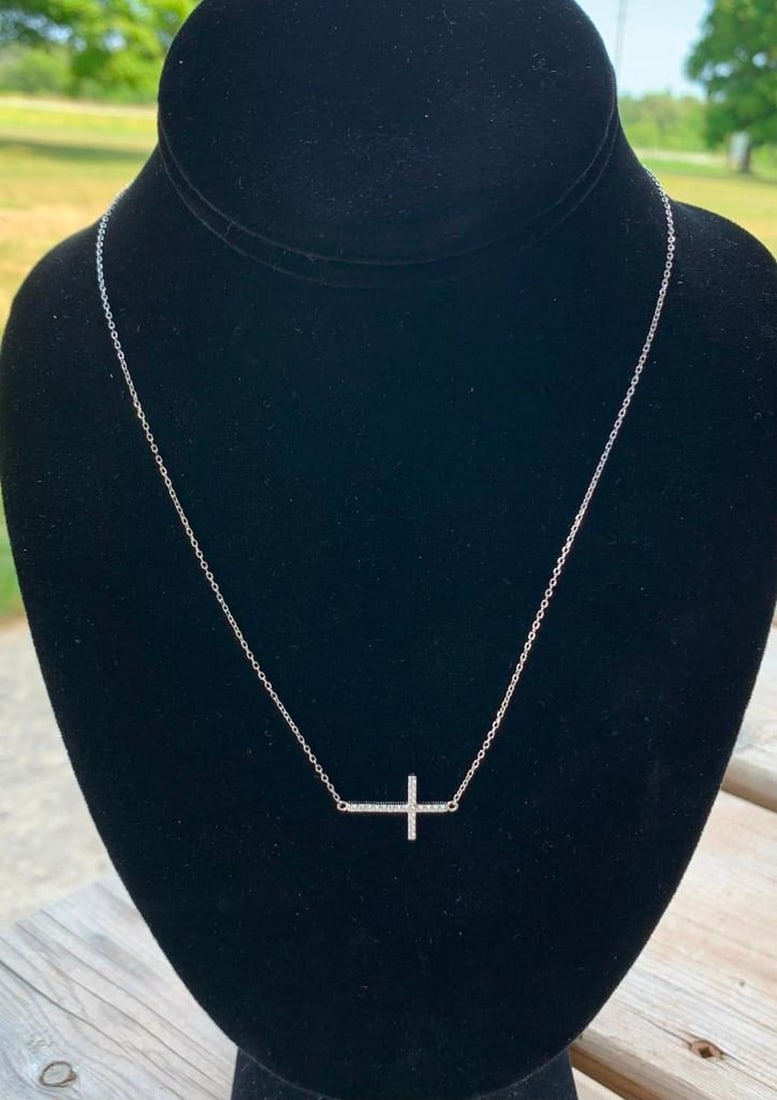 Sterling Silver Sideways Cross Necklace with White Stones: Sterling Silver Sideways Cross Necklace with White Stones A modern take on a timeless symbol, this sterling silver necklace features a beautifully crafted cross pendant adorned with shimmering white s
