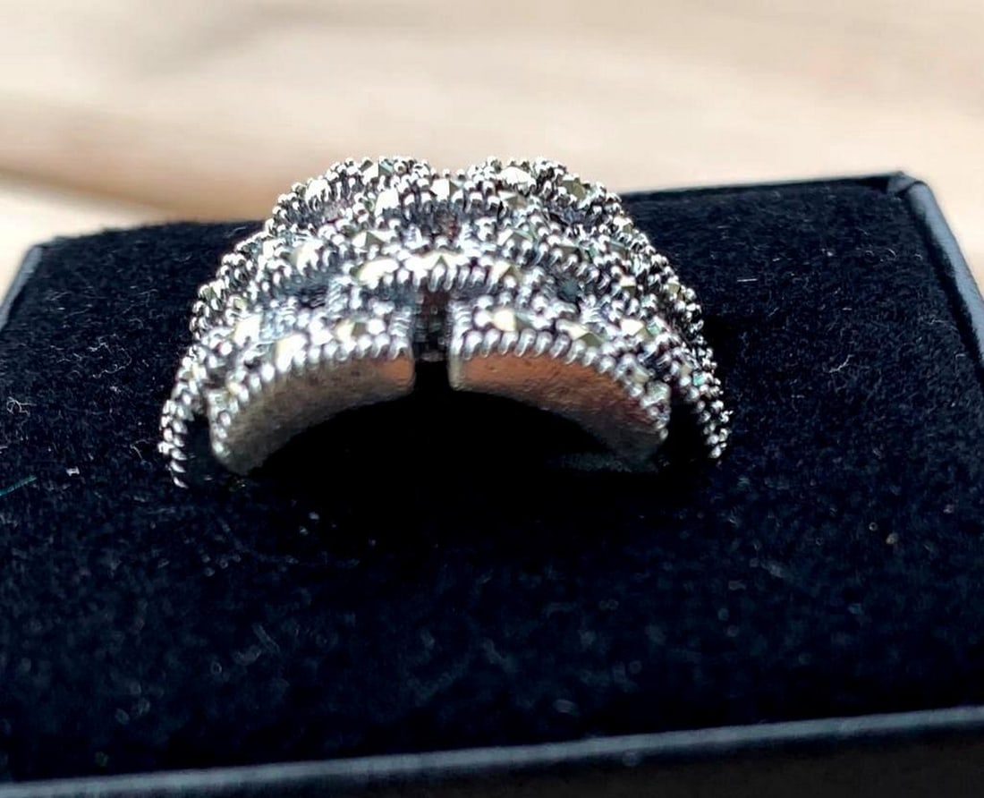 Sterling Silver Basket Weave Ring with Dark Stone Accents: Sterling Silver Basket Weave Ring with Dark Stone Accents Rich in texture and subtle elegance, this sterling silver ring features a detailed basket weave design adorned with scattered dark stones. The