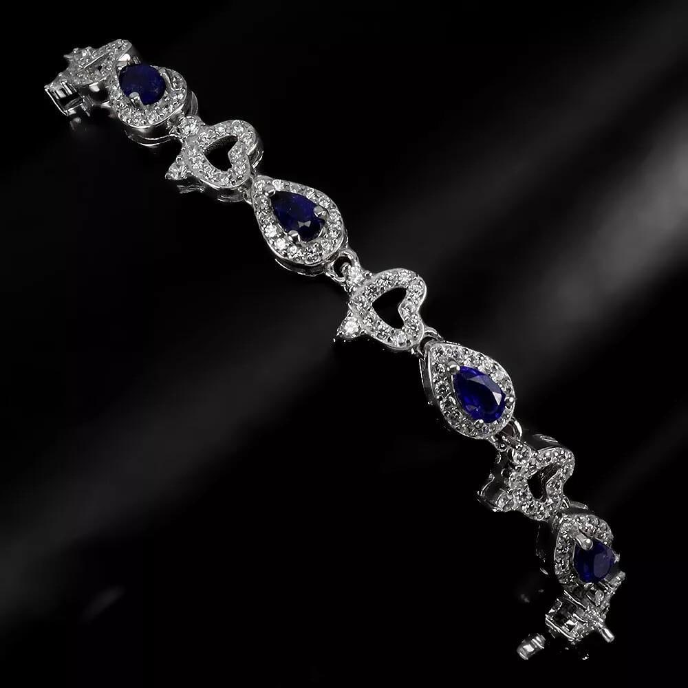 9" Sterling Silver Bracelet with Pear-Cut Blue Sapphire Gemstones: 9" Sterling Silver Bracelet with Pear-Cut Blue Sapphire Gemstones This stunning sterling silver bracelet is adorned with pear-cut blue sapphire gemstones, each measuring 5x3mm. The elegant design 