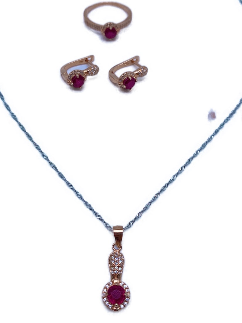 Radical Blood Red Ruby And Austrian Crystal 925 Sterling Silver 14K Rose Gold Plated Set: Radical Blood Red Ruby And Austrian Crystal 925 Sterling Silver 14K Rose Gold Plated Set This set contains a necklace, ring and earrings. All pieces feature a beautiful blood red round Ruby with Austr