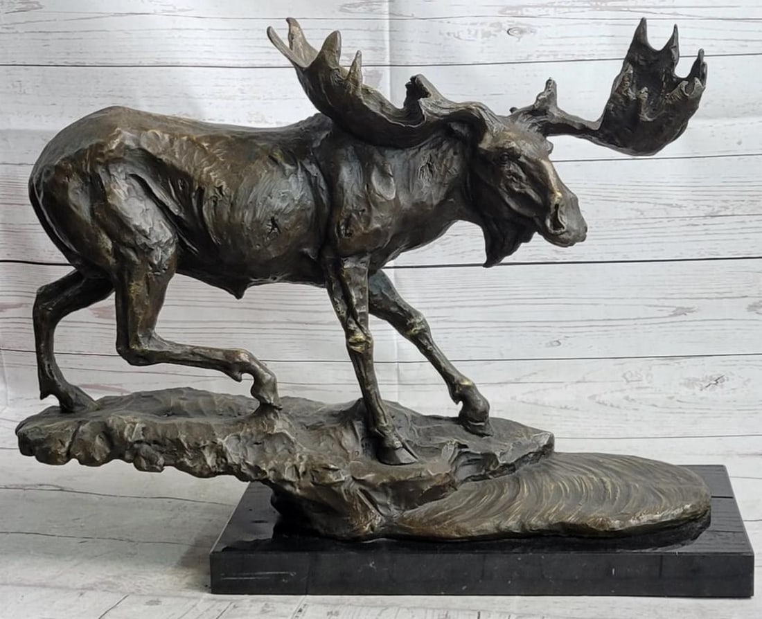 Signed Bugatti Inspired Large Moose Bronze Sculpture - 16" x 23": Signed Bugatti Inspired Large Moose Bronze Sculpture - 16" x 23" This bronze sculpture depicts a moose eating the wet grass from a lake. He bends down into the water keeping his hind legs on h