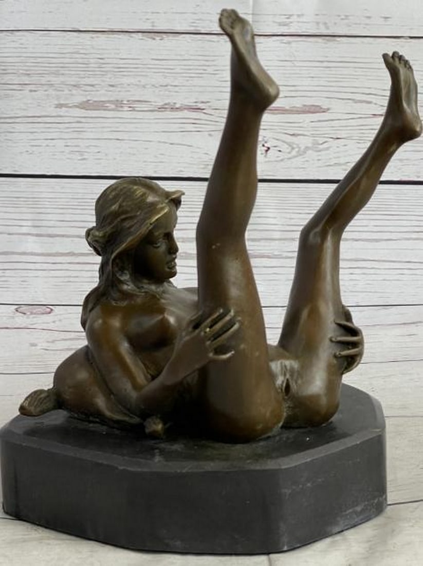 Open Reverie Bronze Sculpture: Open Reverie Bronze Sculpture This powerful bronze sculpture bearing the signature of artist Nino Oliviero captures a deeply intimate moment of a nude woman lying down, holding her legs up and open. T