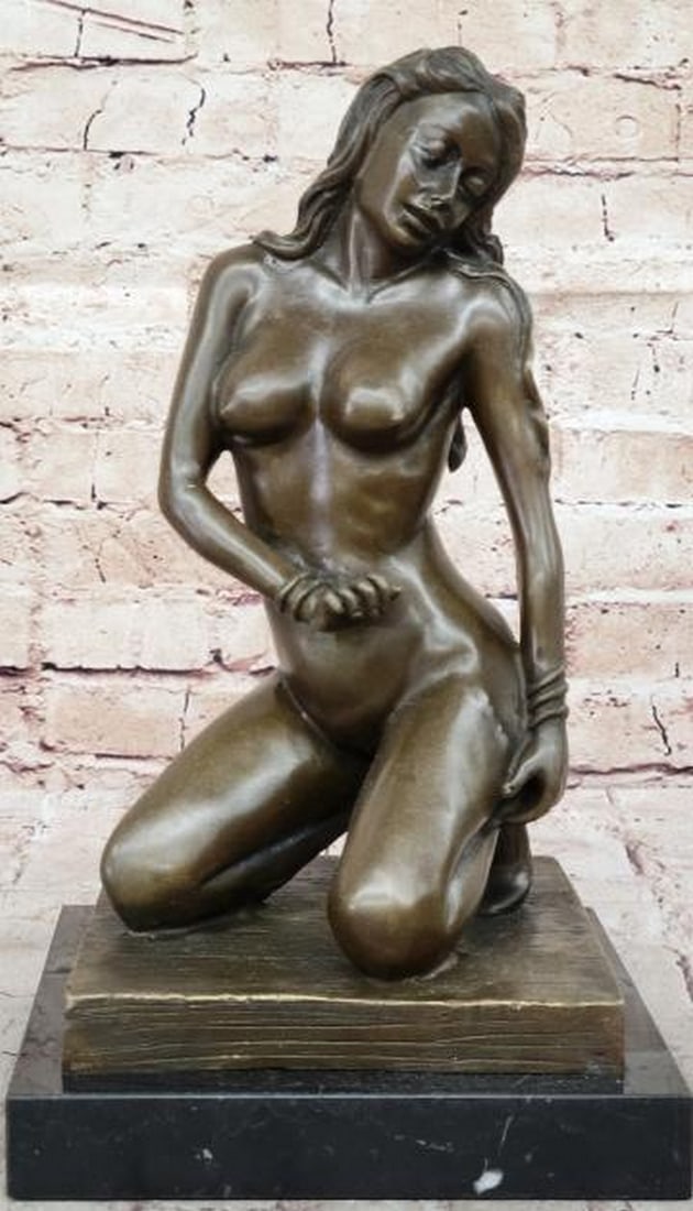 Desire in Bronze Sculpture: Desire in Bronze Sculpture. This captivating bronze sculpture, bearing the signature of artist John Koch, explores the sensuality and beauty of the human form. The piece features a nude figure in a mo