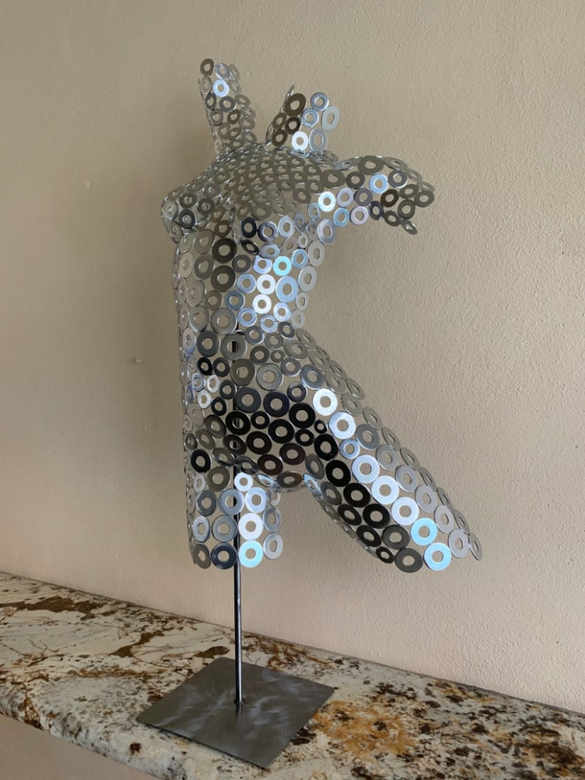Chrome Metal Female Torso Sculpture: Chrome Metal Female Torso Sculpture This striking female torso is a powerful addition to any art collection. Inspired by Native American roots, the artist transforms the cold hardness of steel into