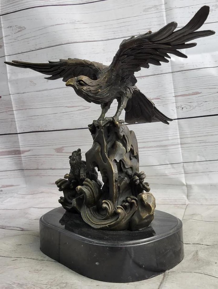 Original Eagle Landing on Waves Bronze Sculpture - 13" x 13": Original Eagle Landing on Waves Bronze Sculpture - 13" x 13" This bronze sculpture depicts a bird with its wings open, standing on a fluid-like bronze plinth. The bird appears to be absorbing 