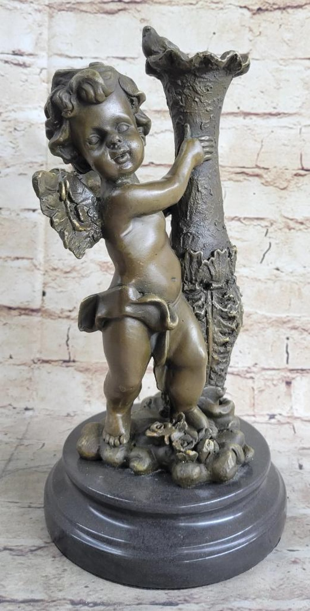 Cherub Angel Bronze Sculpture On Marble Base - 12" x 5.5": Cherub Angel Bronze Sculpture On Marble Base - 12" x 5.5" The cherubic angel seems to have just landed from great heights among the ruins of an old enchanted garden. He holds himself steady fr