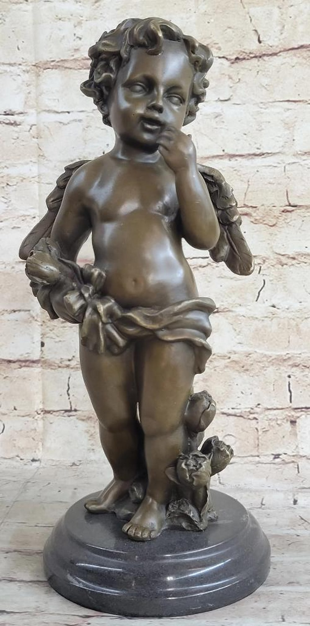 Art Nouveau Winged Cherub Bronze On Marble Base - 10lbs: A gorgeous cherub is walking in the meadow picking blossomed roses. There flowers cradled in his arm and fresh ones in the ground standing as high as the cherubs thighs. The features of this sculpture